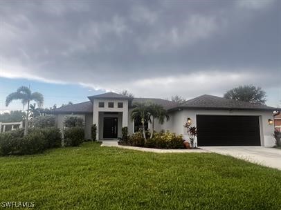 a front view of a house with a yard and a garage