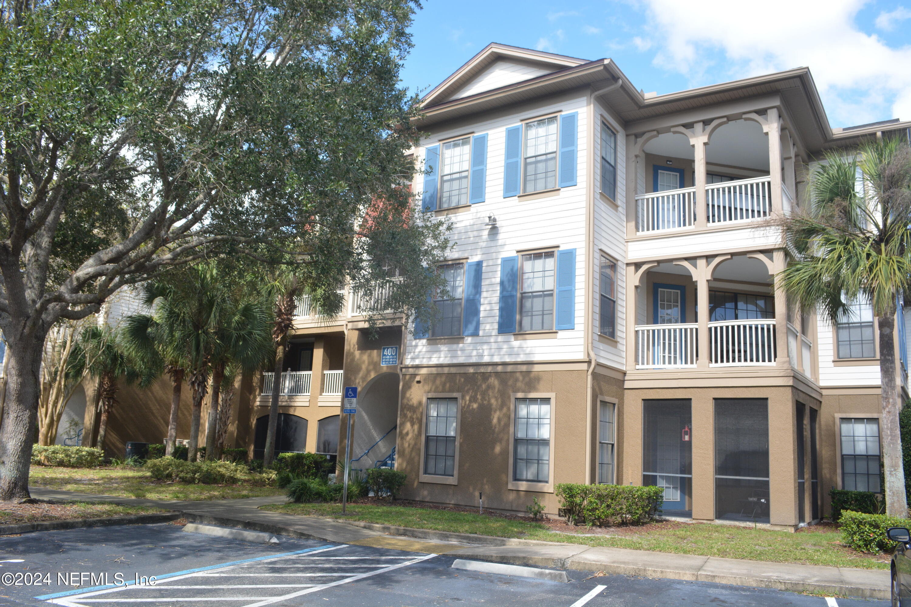 a front view of a residential apartment building with a yard