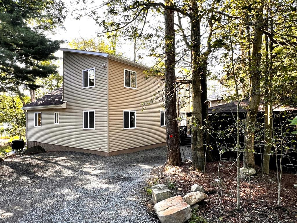 a view of a house with yard and sitting area