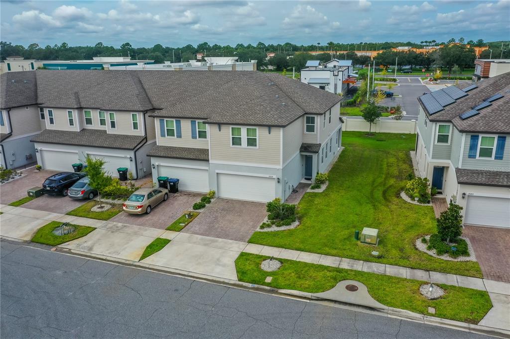 an aerial view of a house with a garden and street view