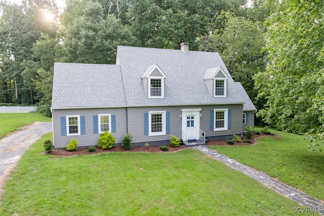 a aerial view of a house with swimming pool and porch with green space