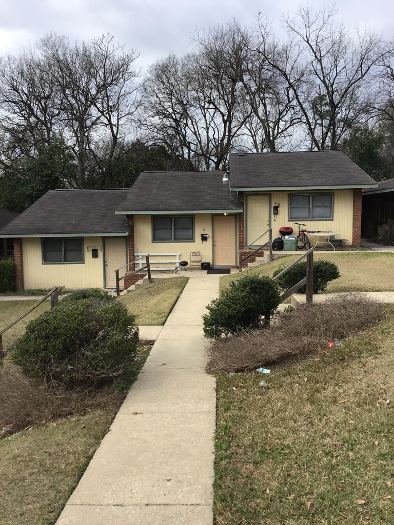 a front view of a house with yard and green space