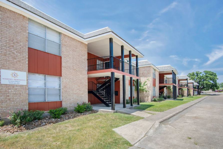 a view of a building with a yard