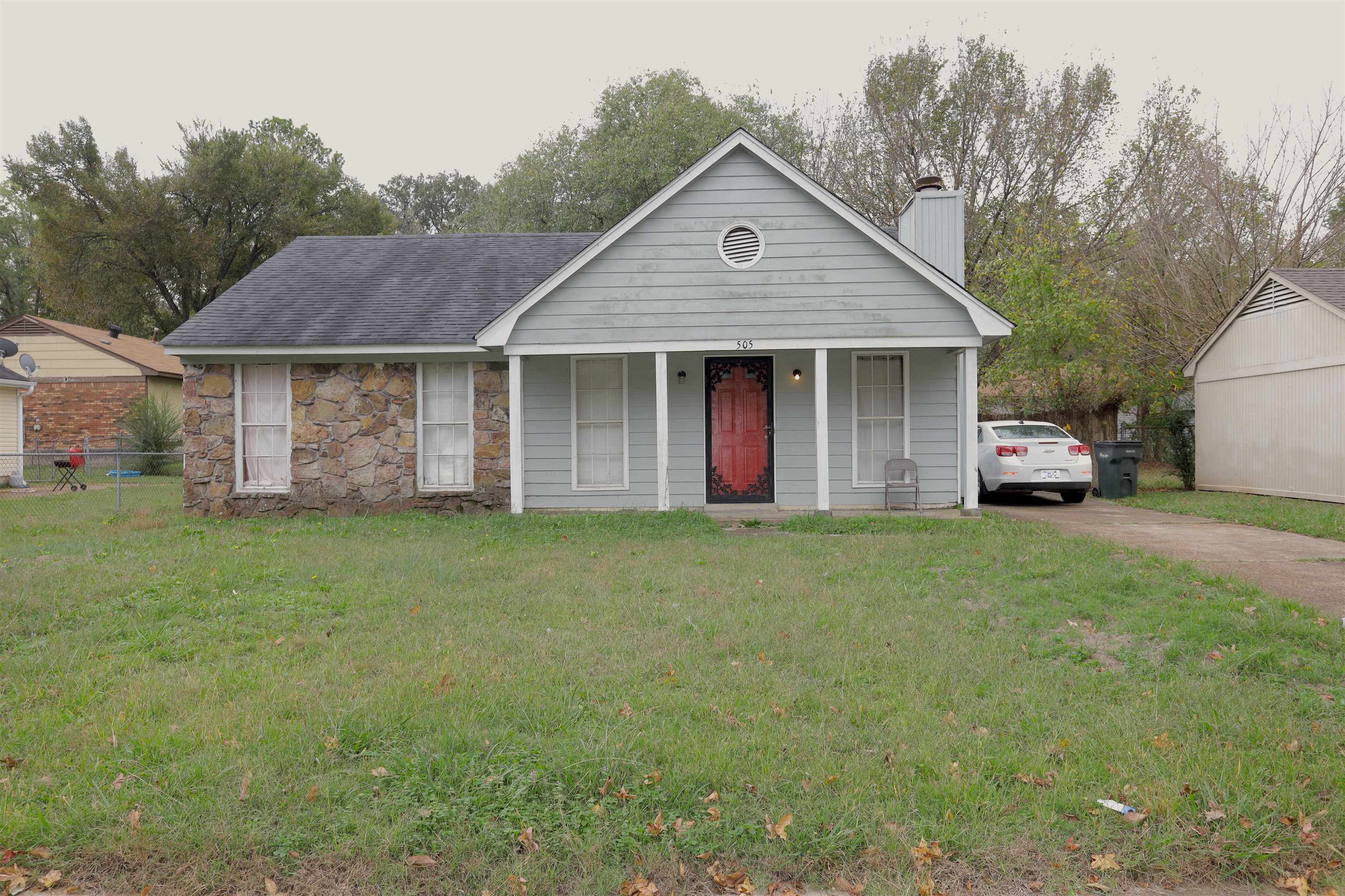 a front view of a house with a garden and garage