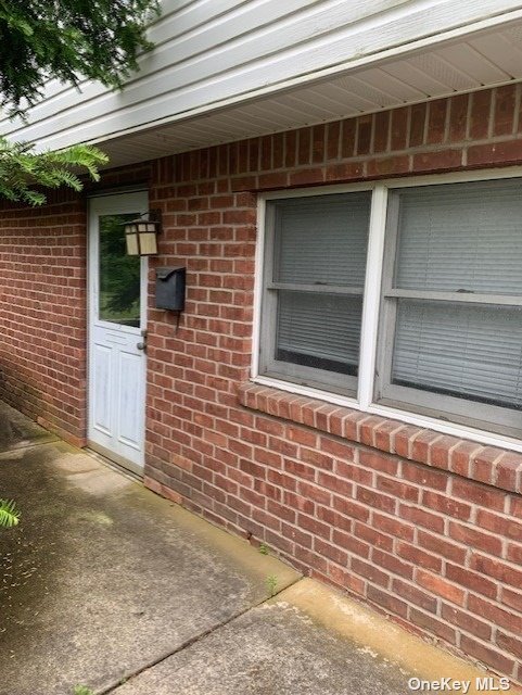 a view of front door of house with wooden door