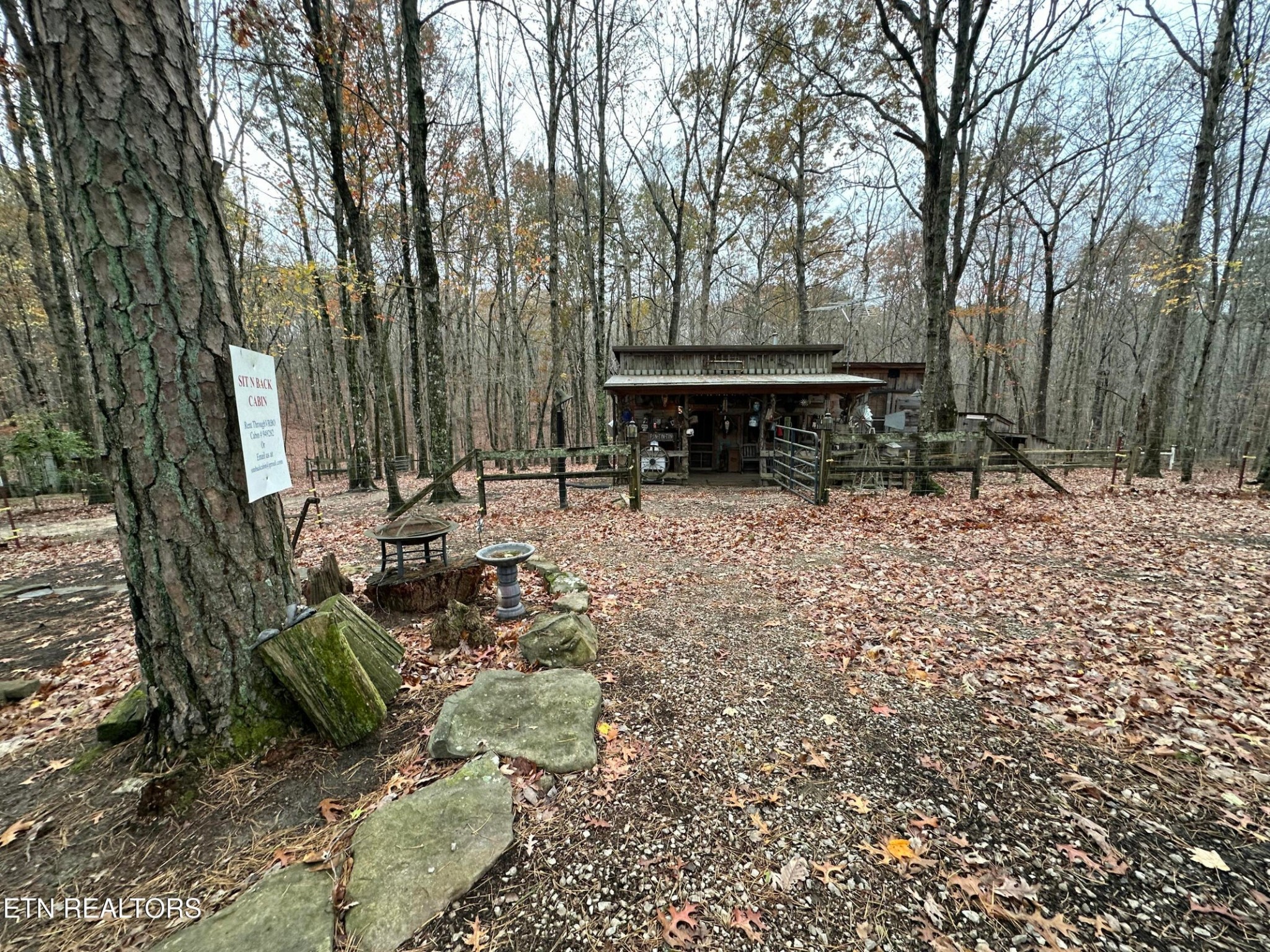 a view of a chairs and tables in the back yard of the house