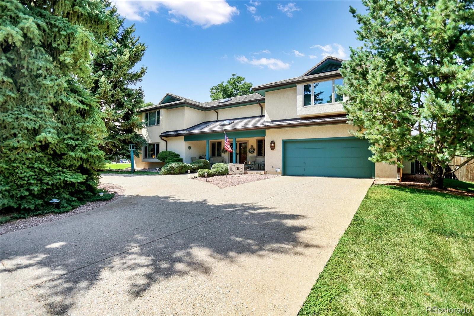 a front view of a house with a yard and a garage