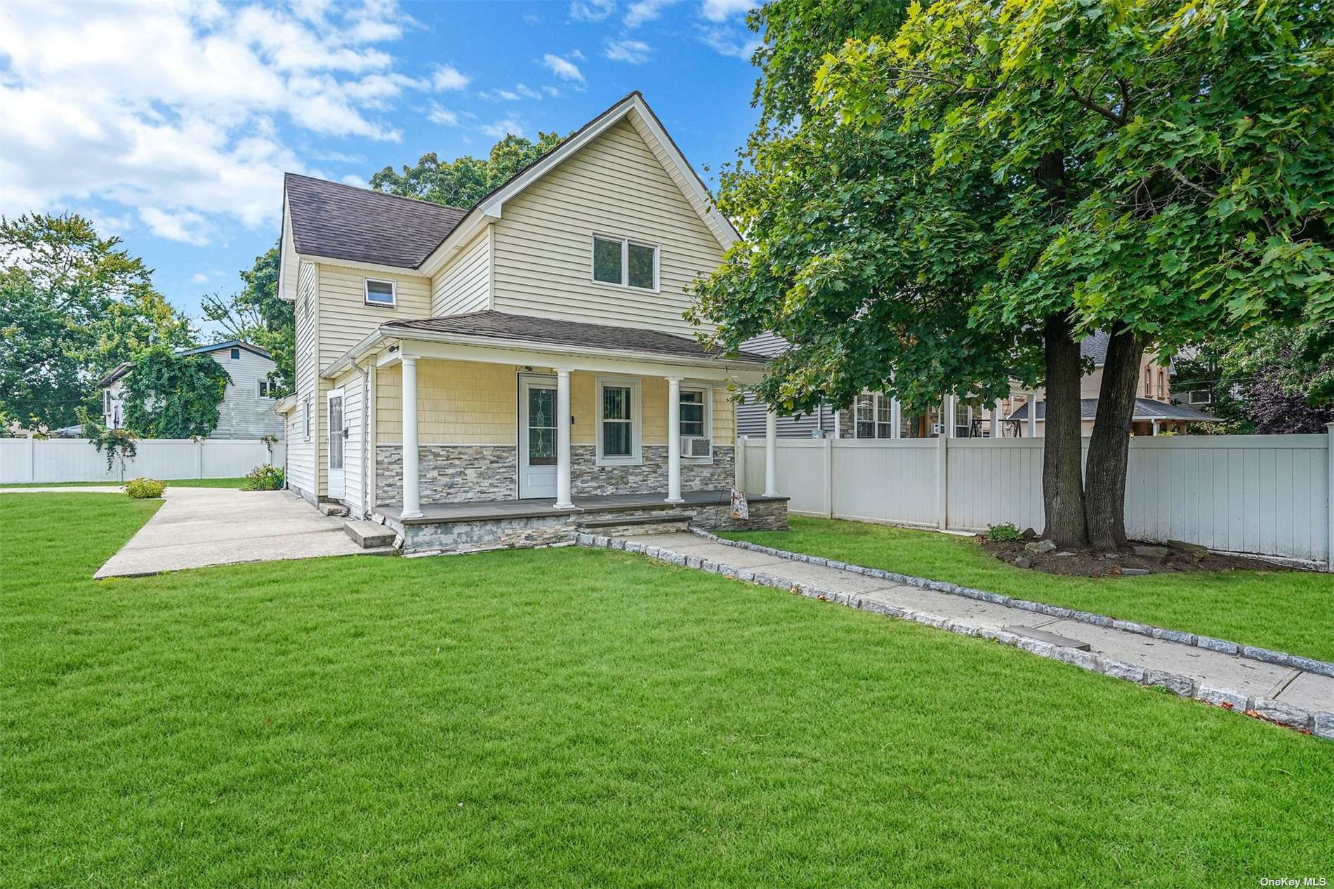 a view of a house with a yard patio and a small yard