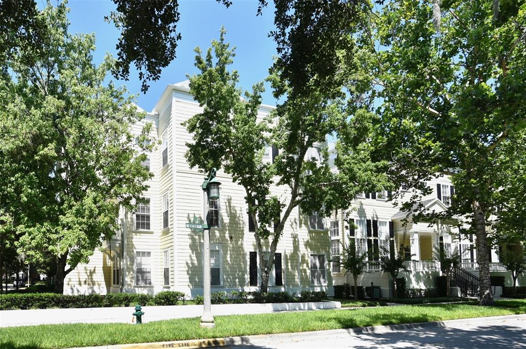 front view of a white house with a yard