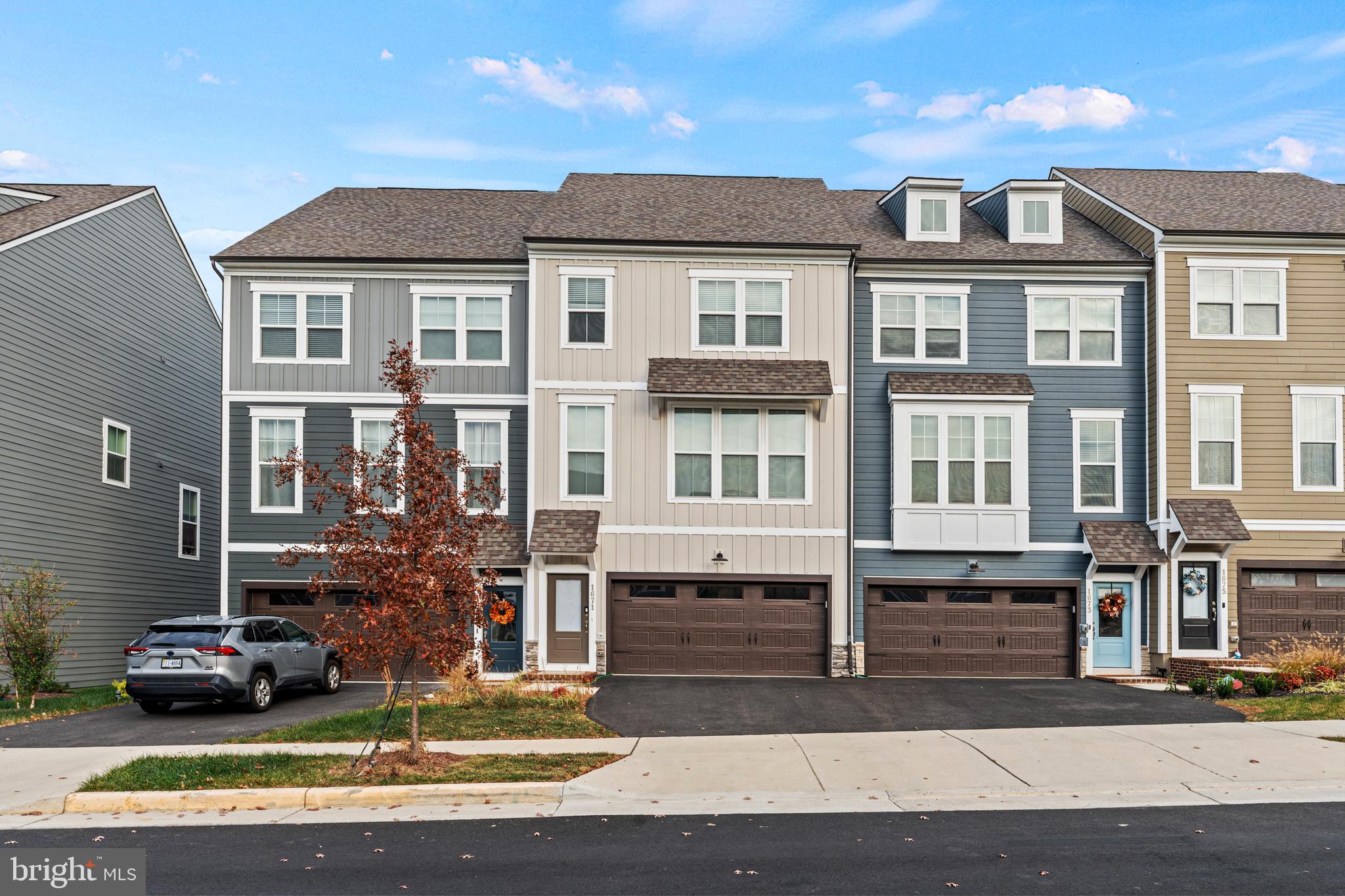 a front view of a residential apartment building with a yard