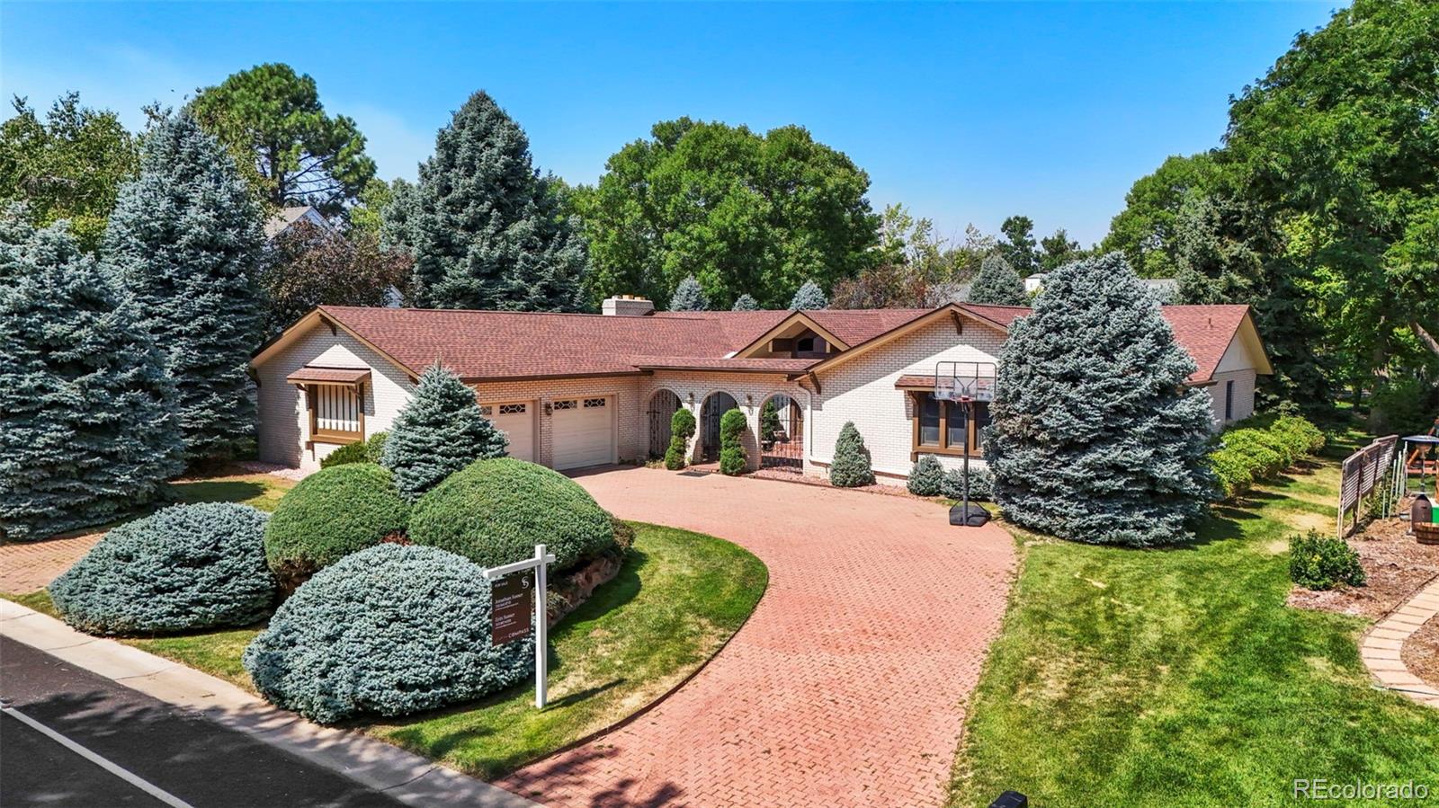 a aerial view of a house with a yard and potted plants