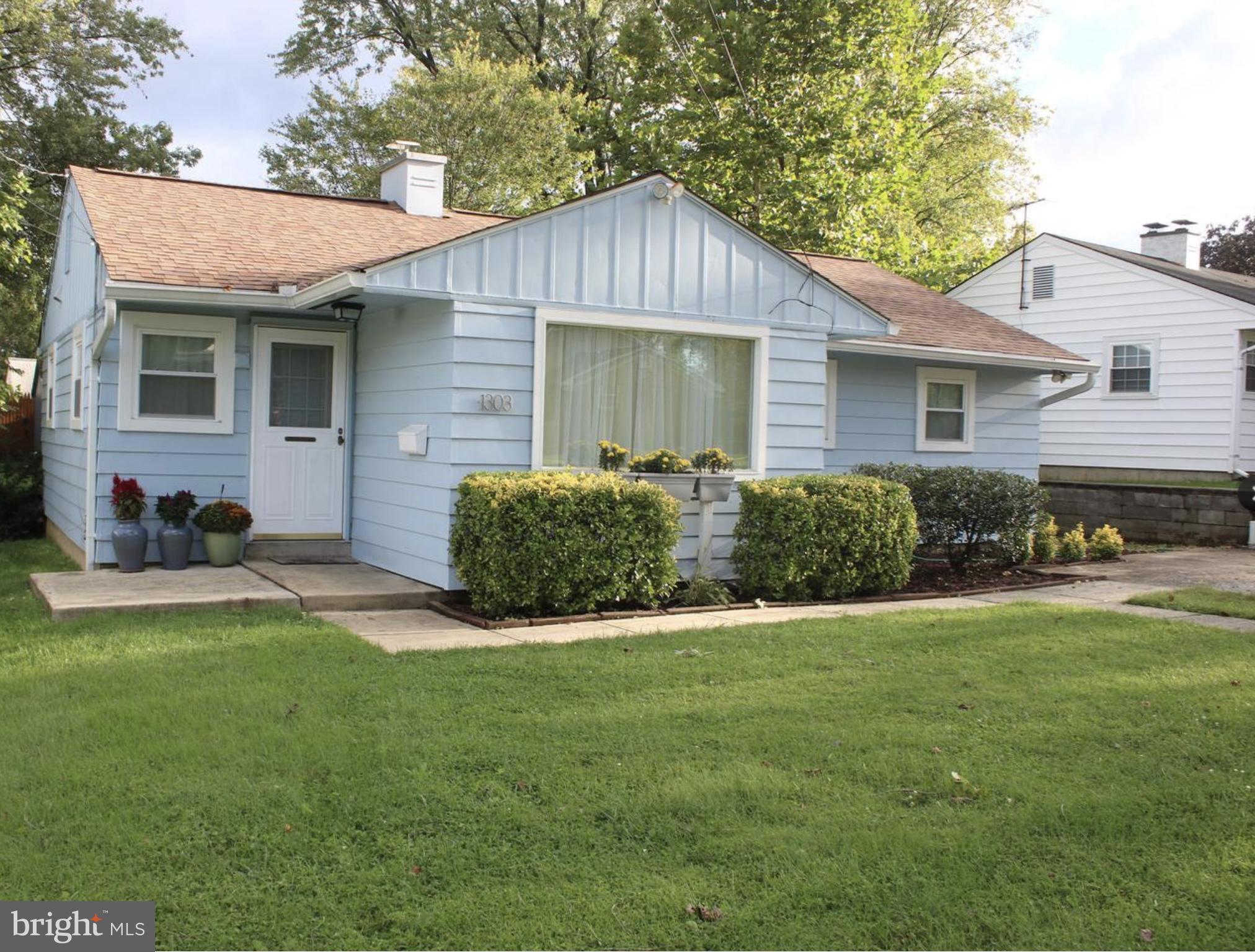 a view of a house with a yard and sitting area