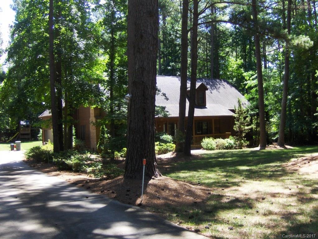 a view of a house with a yard garage and sitting area