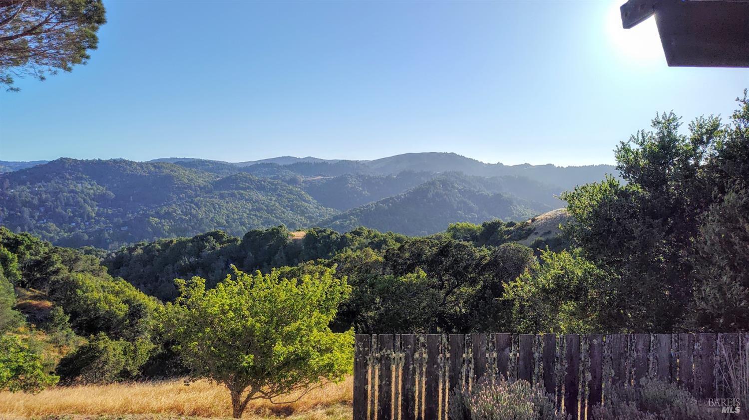 a view of a house with a mountain in the background