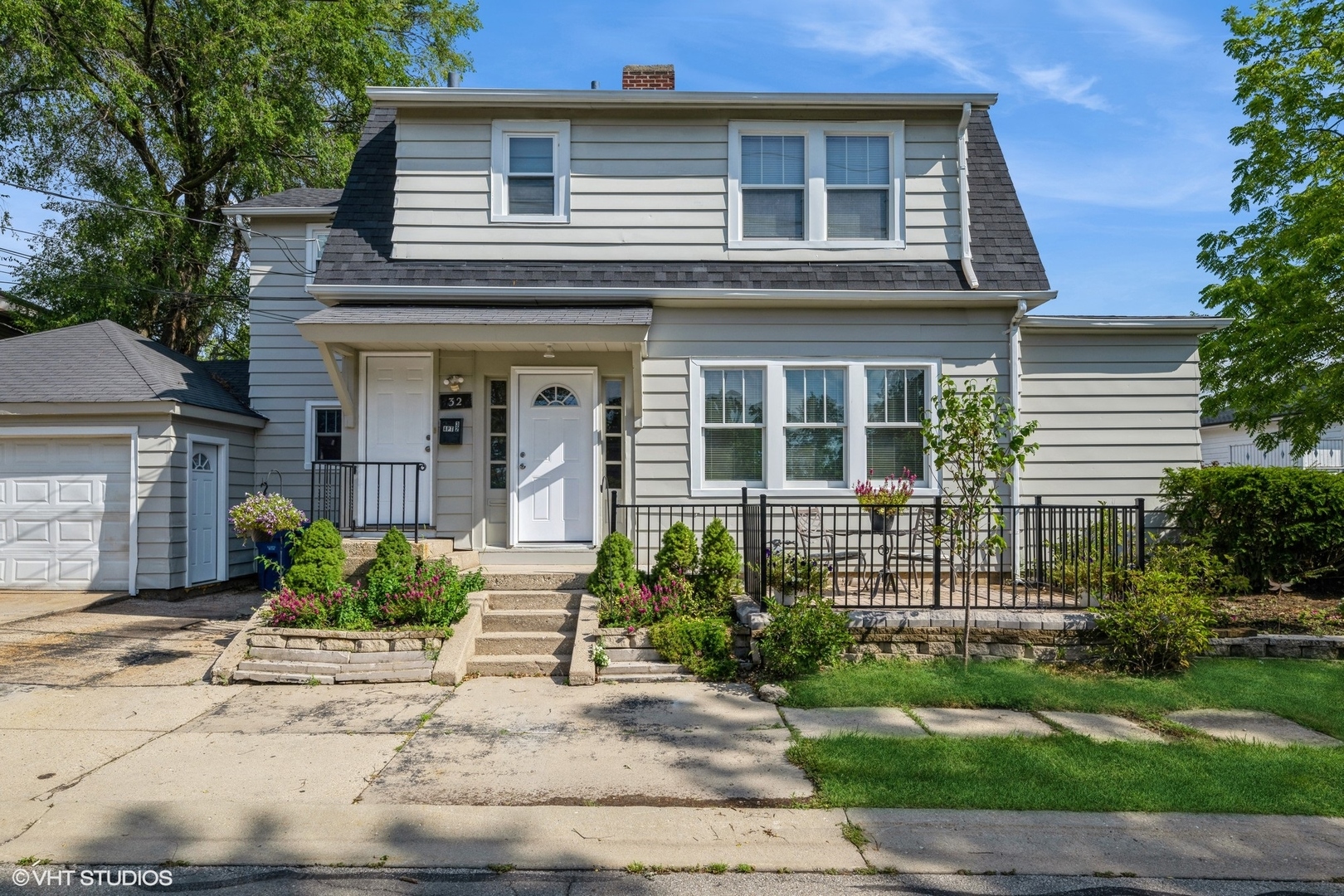 a front view of a house with garden