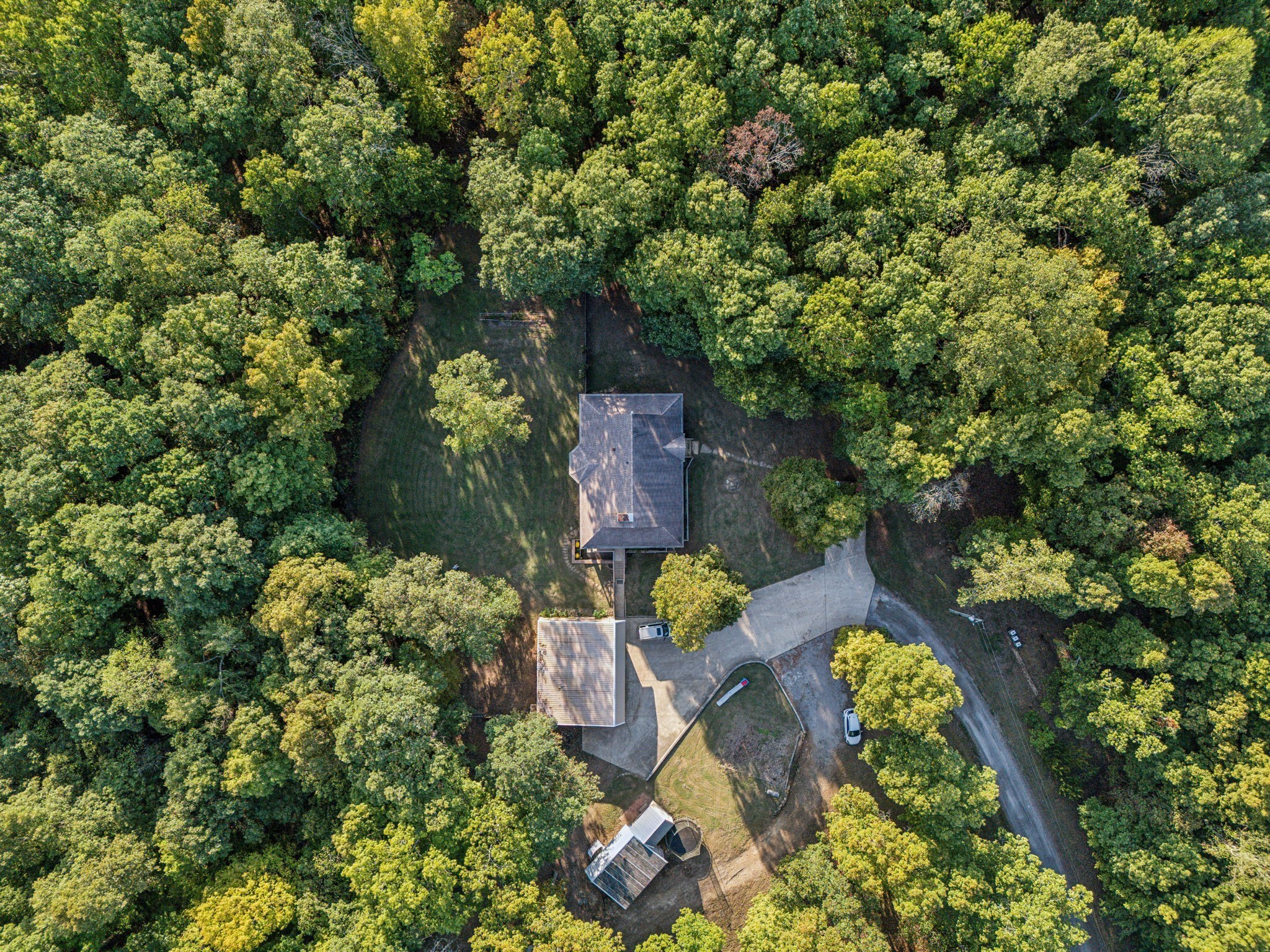 an aerial view of a house with a yard basket ball court and outdoor seating