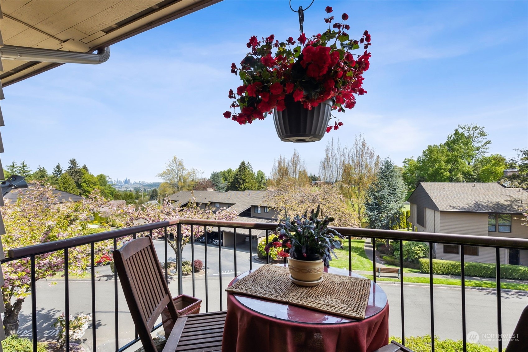 a view of a balcony with dining table and chairs