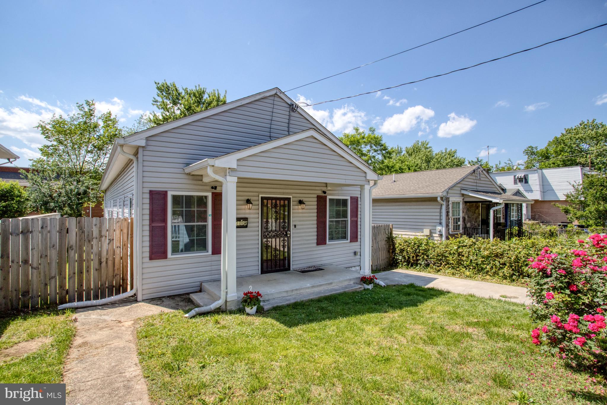 a front view of a house with a yard and porch