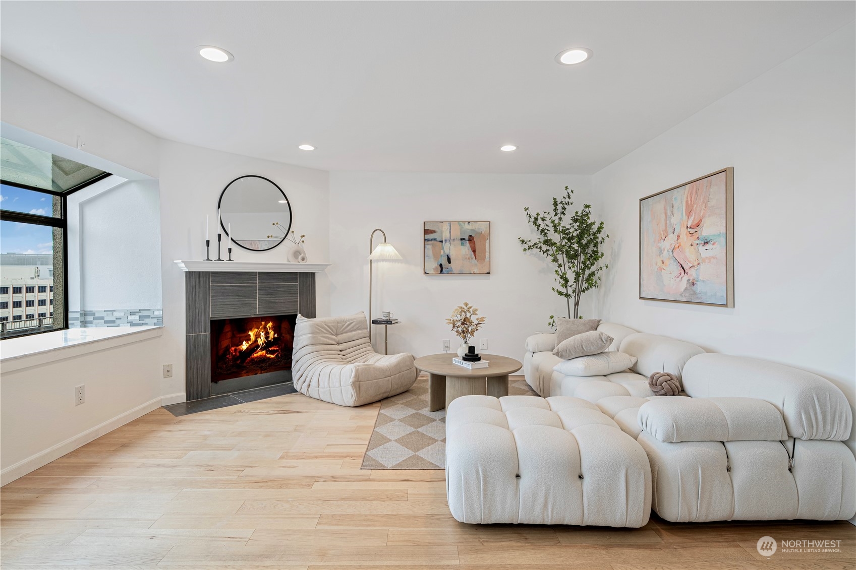 a living room with furniture a fireplace and window