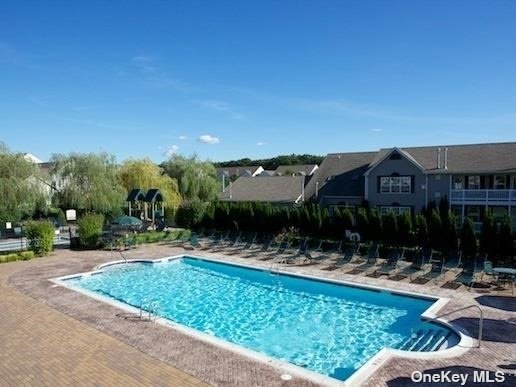 a large building with swimming pool in front of it