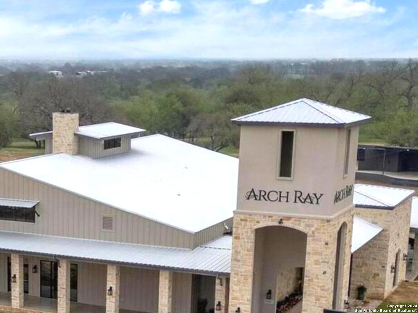 a view of a house with roof deck and furniture