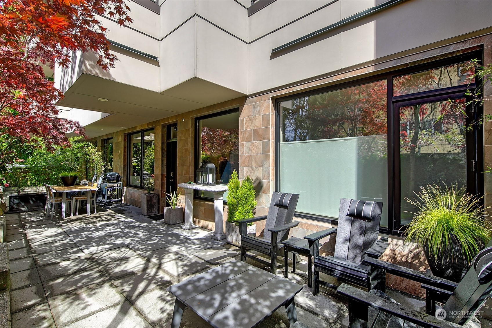 a view of a patio with table and chairs and potted plants