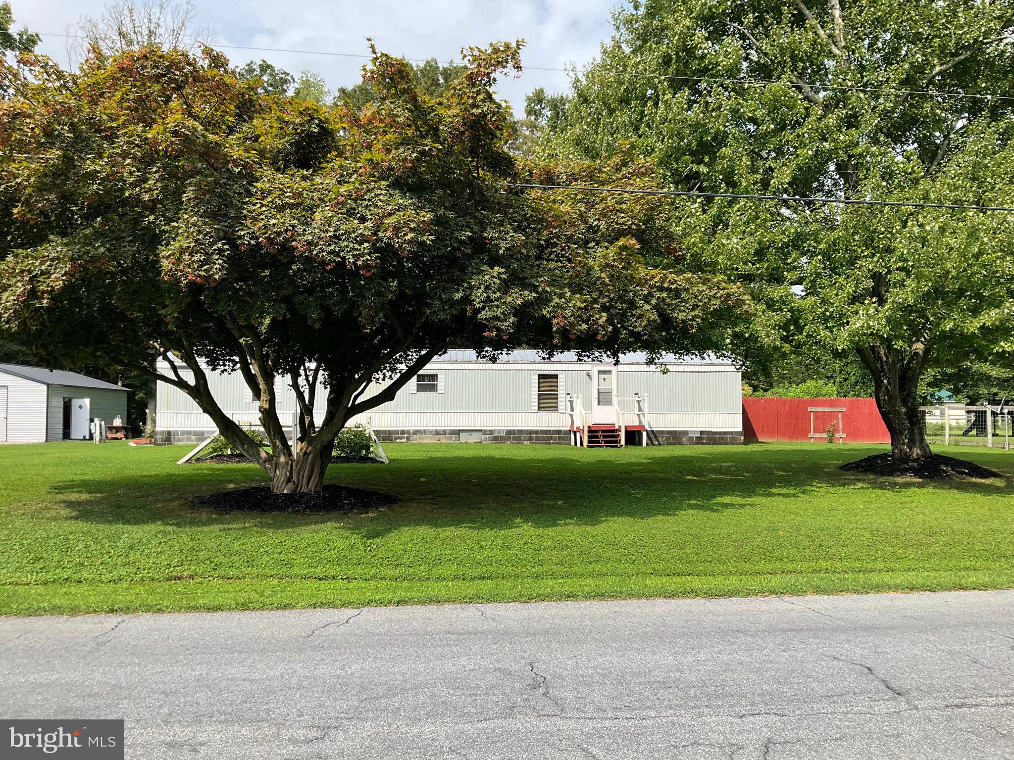 a view of a yard with a house in the background