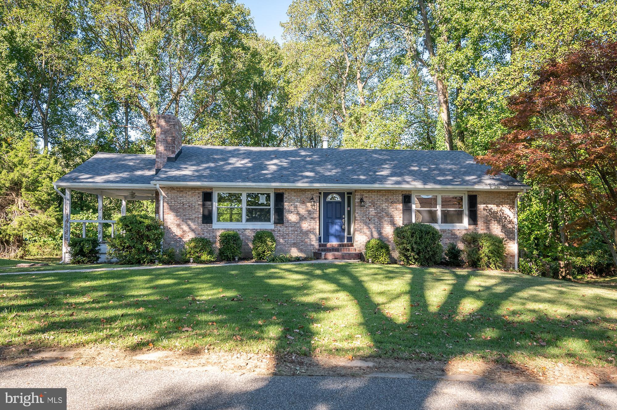 a view of a house with a yard and sitting area