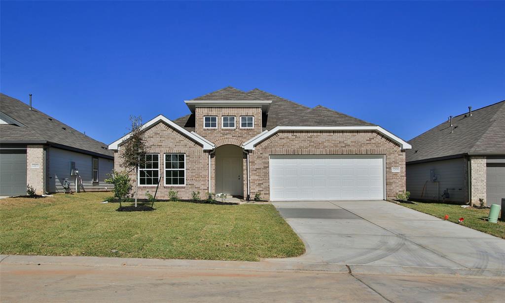 a front view of a house with garage