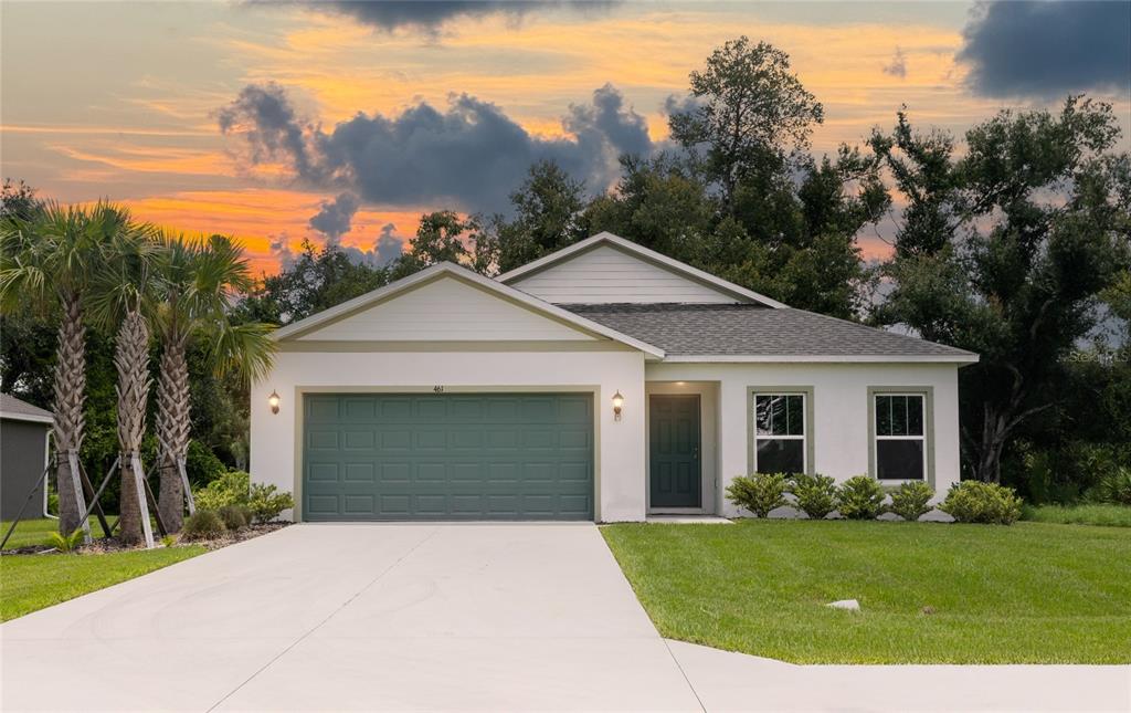 a front view of a house with a yard and garage