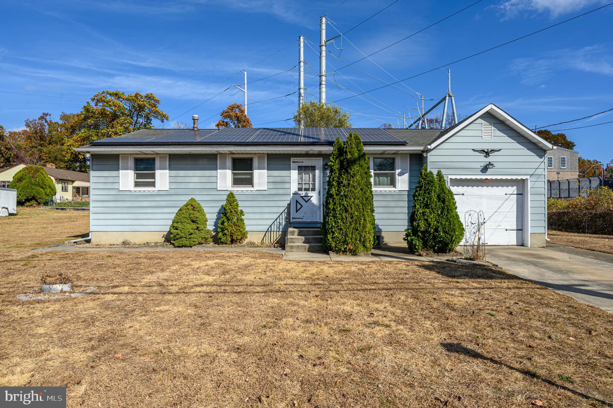 a front view of a house with a yard and a garage