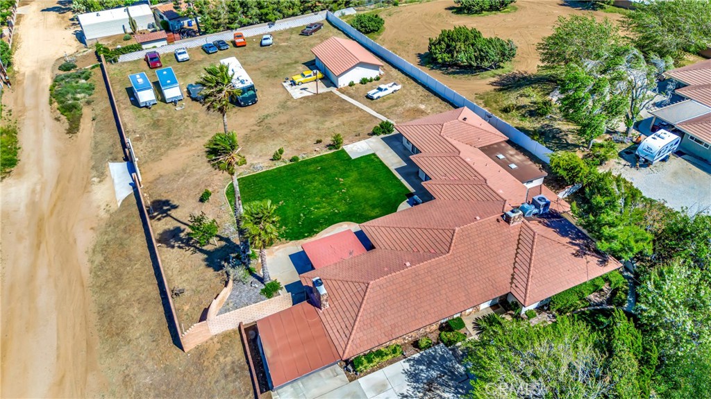 an aerial view of a house with a garden and trees