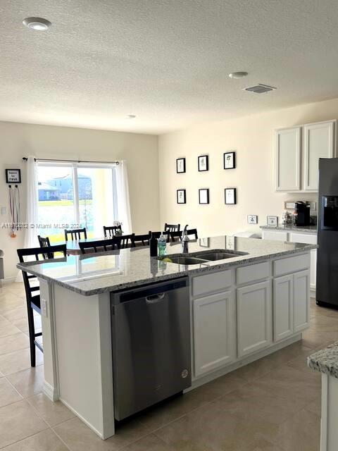 a kitchen with granite countertop a sink stove window and cabinets