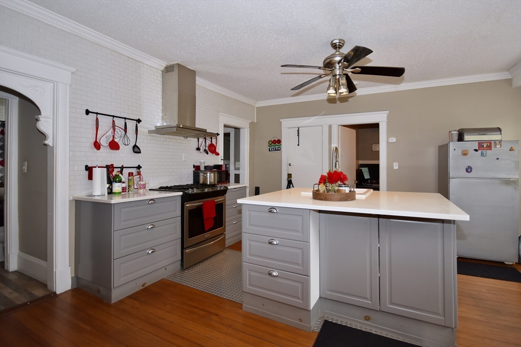 a kitchen with a sink dishwasher refrigerator and cabinets