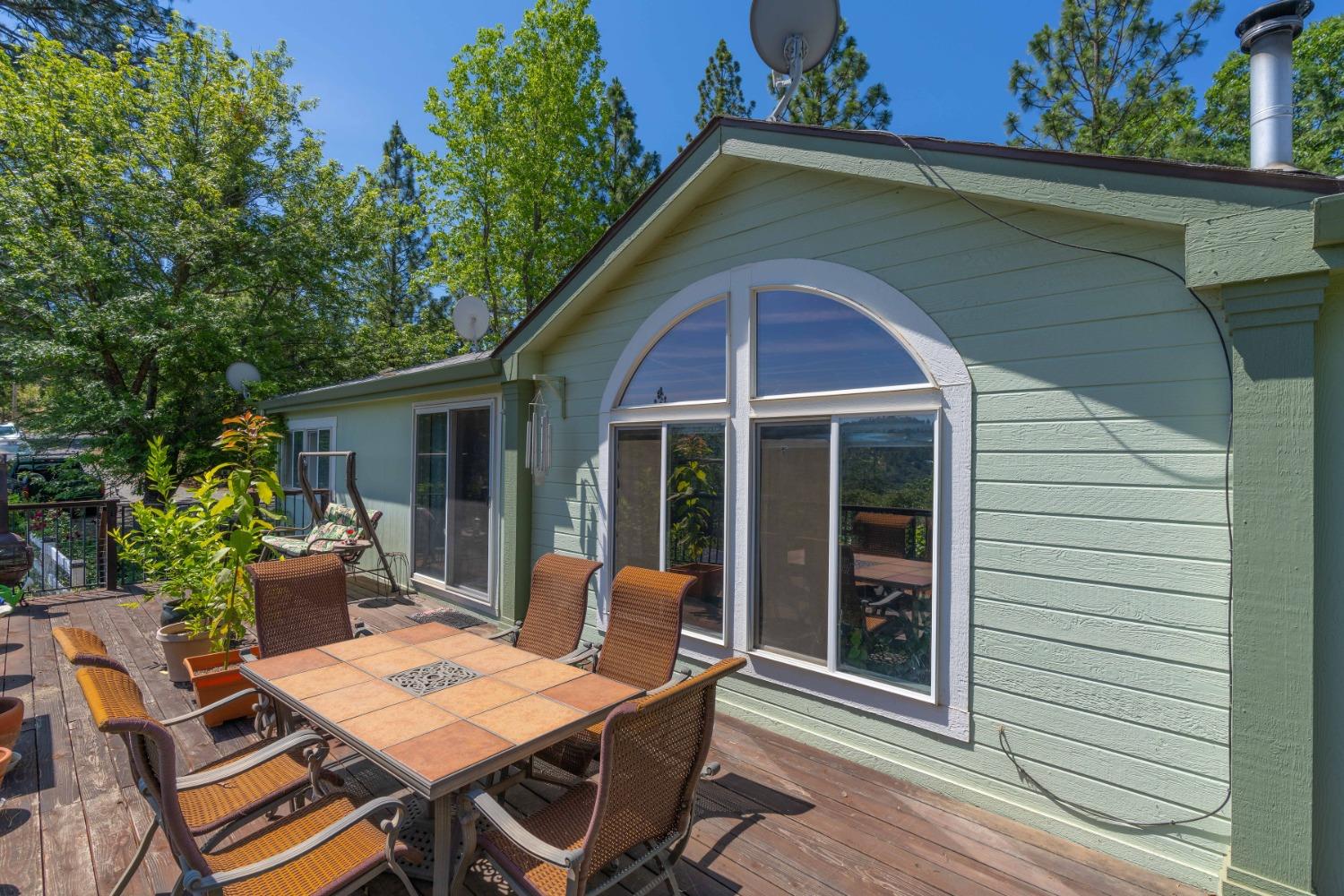 a view of a house with a chairs and table in a patio