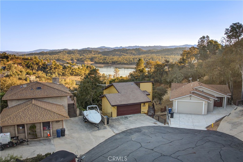 an aerial view of a house with a garden and mountain view