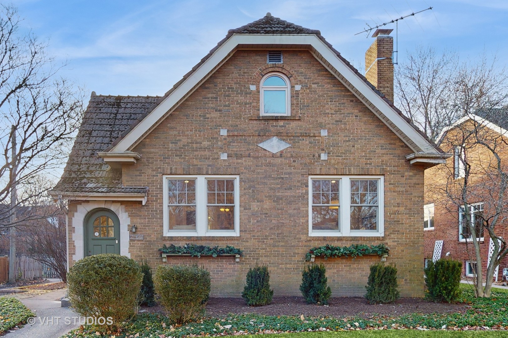 a front view of a house with a garden