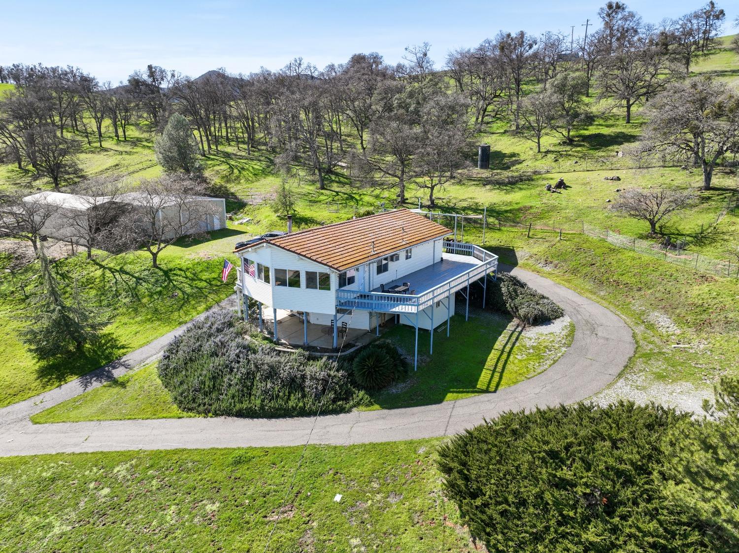 an aerial view of residential houses with outdoor space and trees