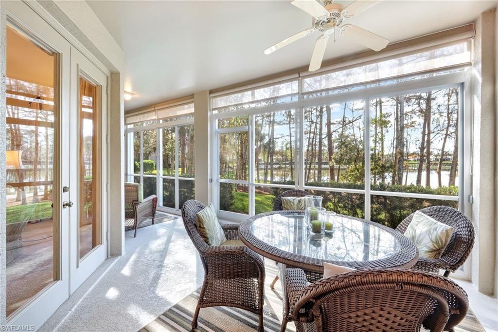 Sunroom featuring ceiling fan, a water view, and french doors