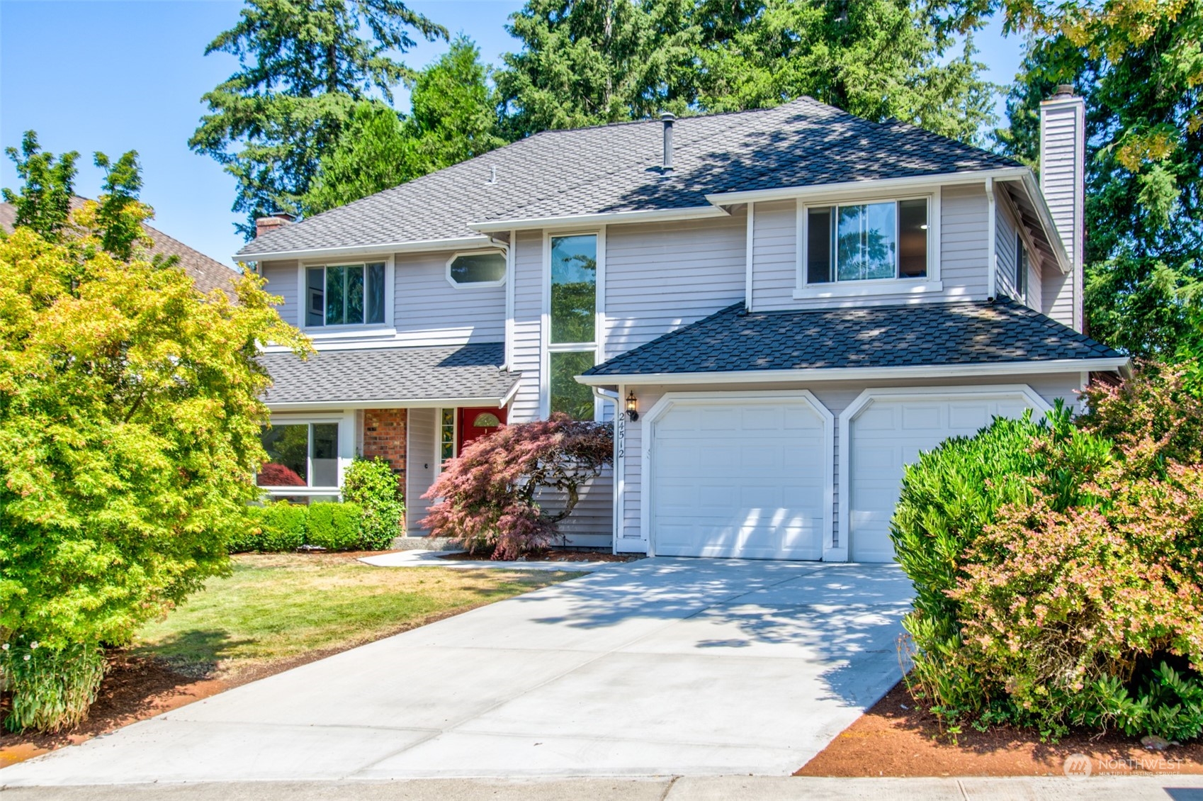 a front view of a house with a yard and garage