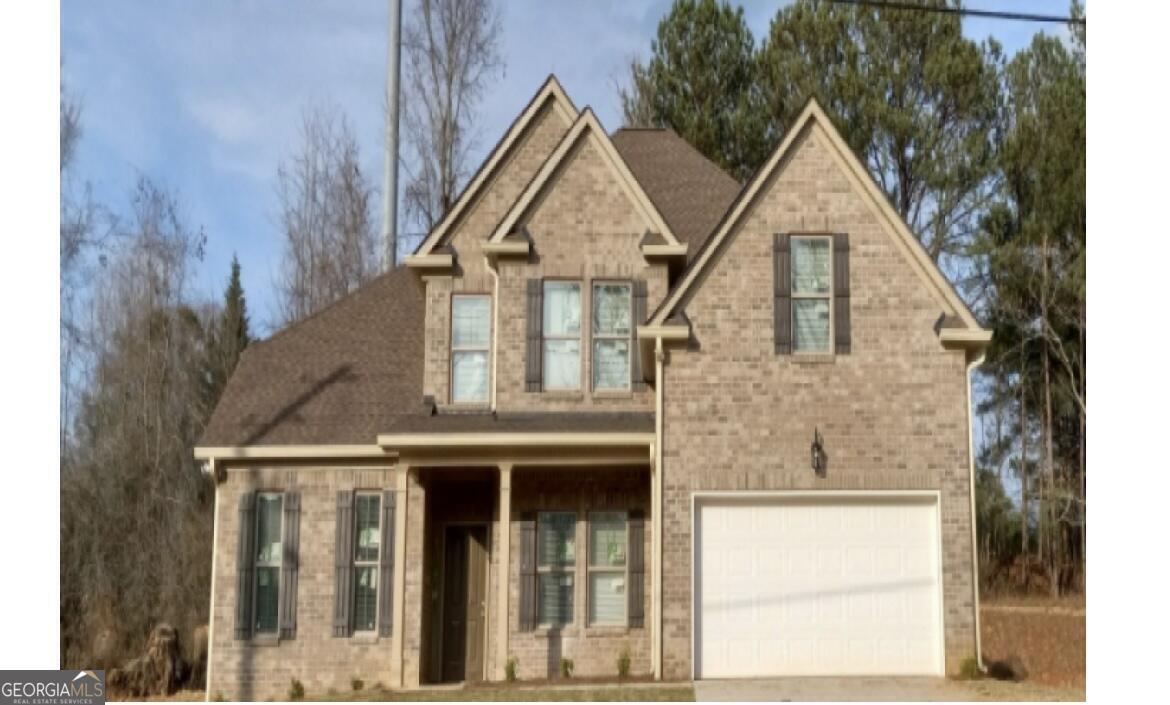 a view of a brick house with large windows