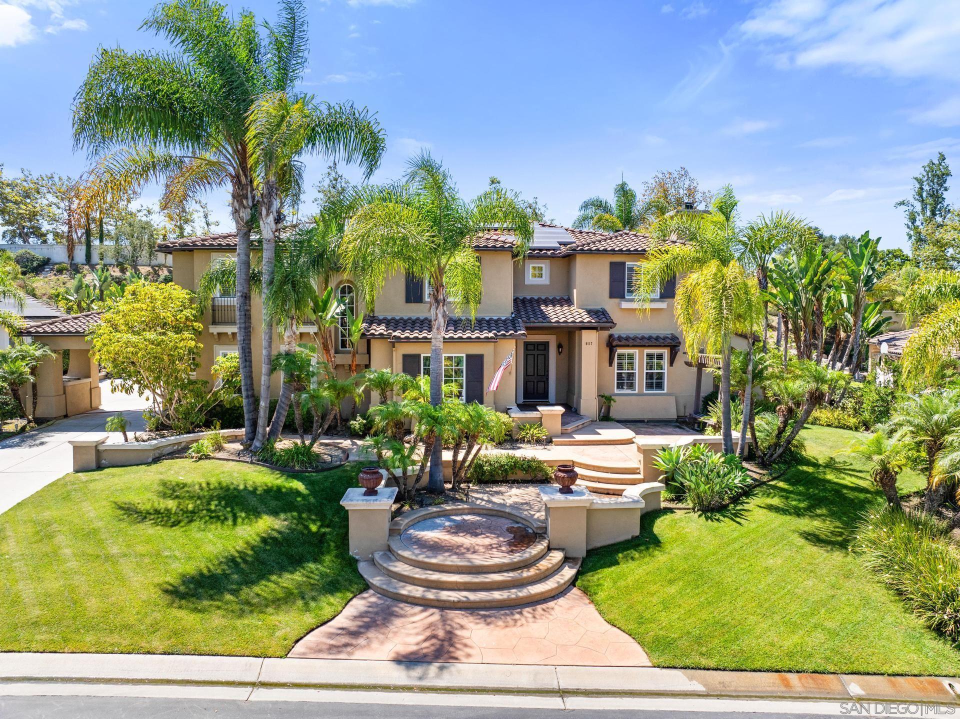 a front view of a house with garden and patio