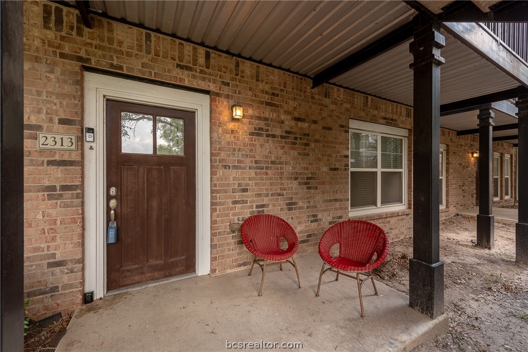 a backyard of a house with table and chairs