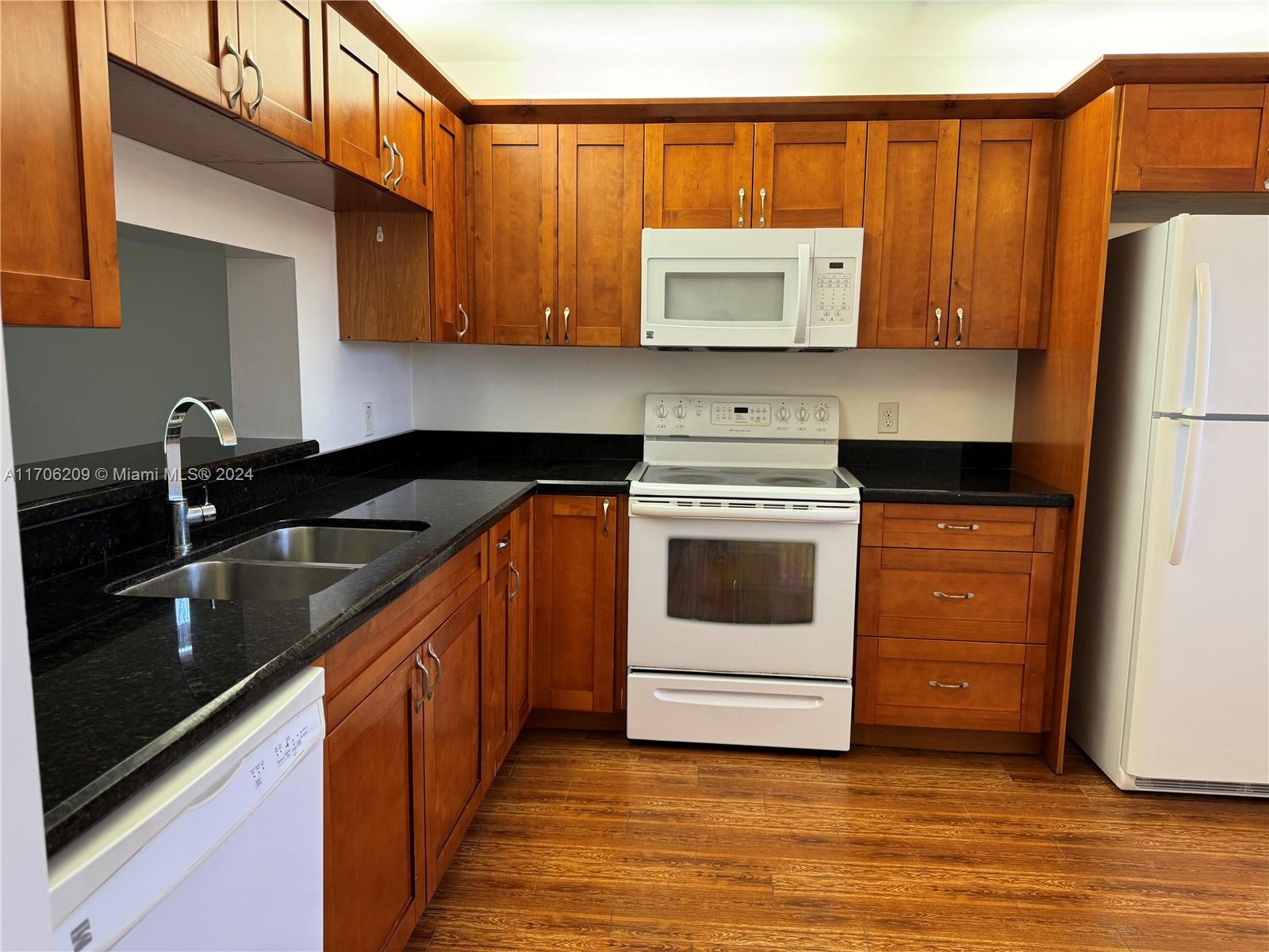 a kitchen with a sink stove and microwave