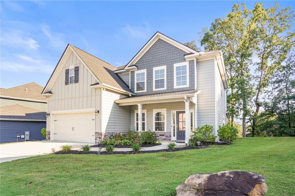 a front view of a house with a yard and garage