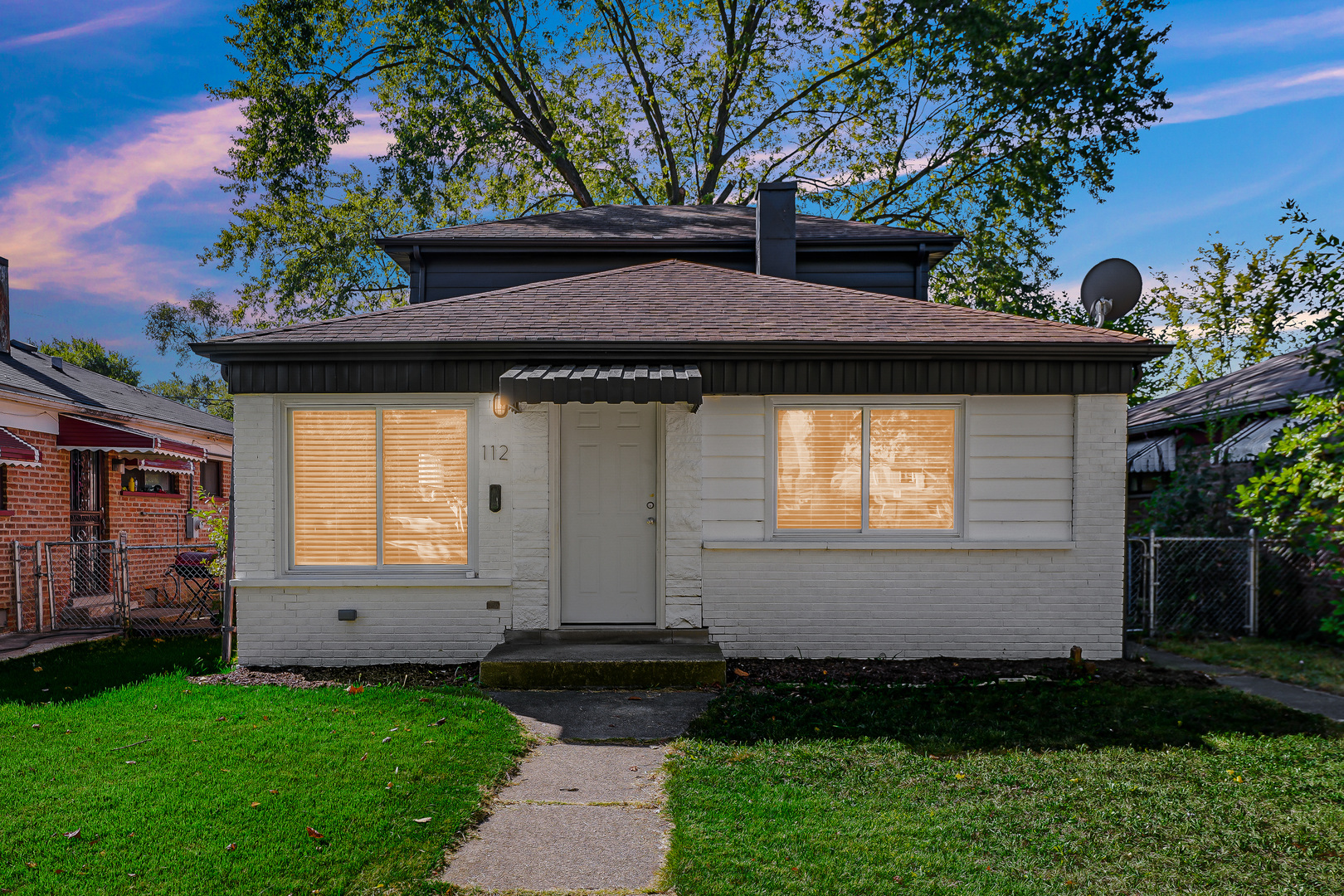 a front view of a house with a garden