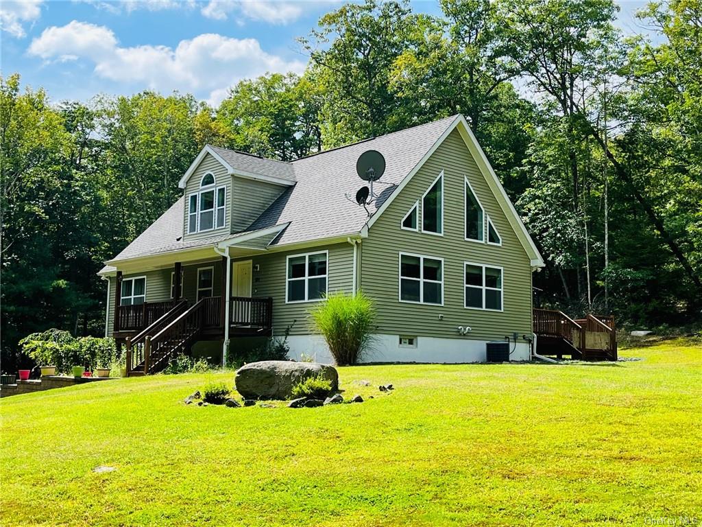 a front view of house with yard and green space