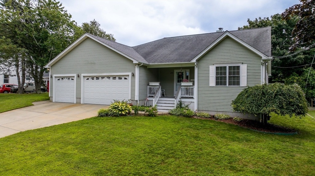 a view of a house with a yard and plants