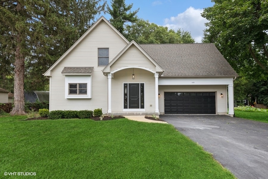 a view of house with yard and green space