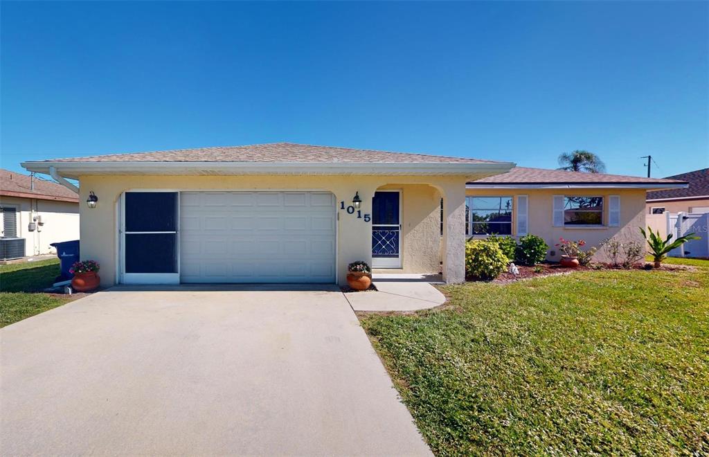 a front view of a house with a yard and garage